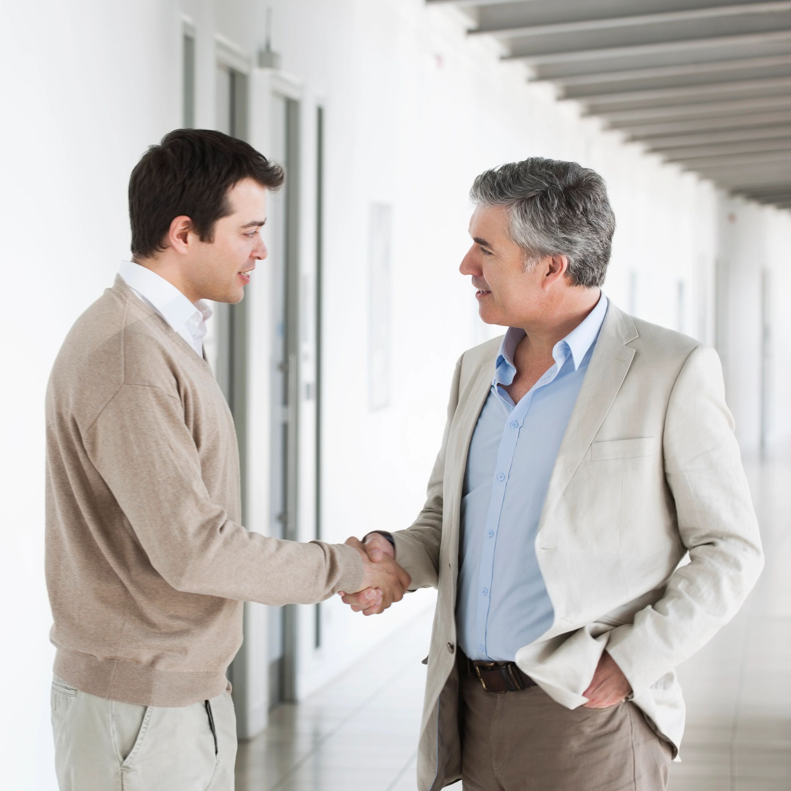 Two professionals shaking hands after an agreement