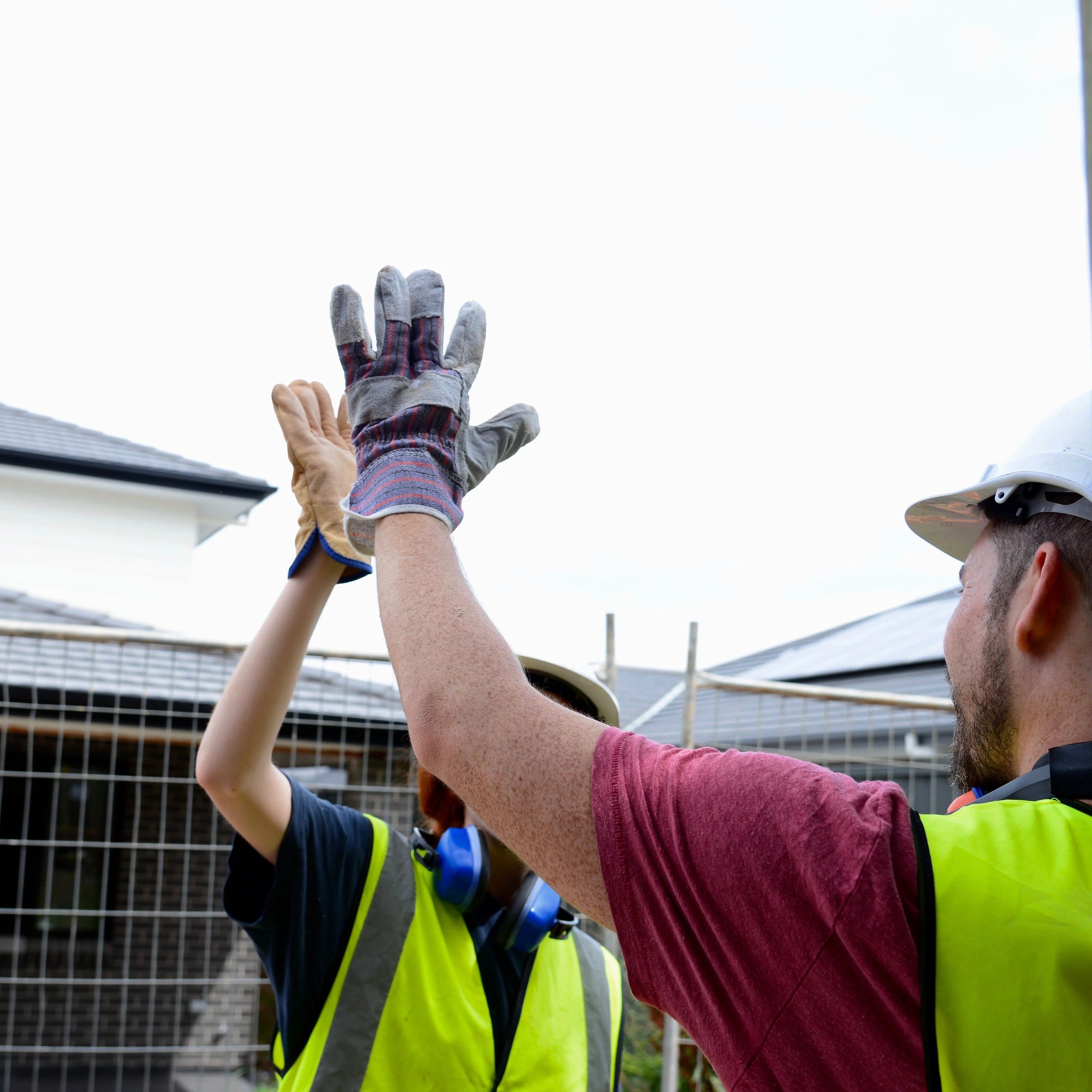Construction team celebrating a completed project with a high-five